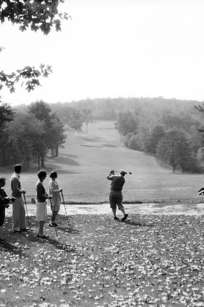 Golf: 1920s-1930s Group Of Golfers Teeing Off 2 Men 2 Women And 2 Caddies At The Country Club Pittsfield Berkshires Ma by Vintage Images