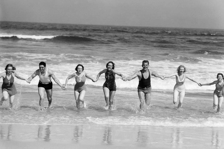 1930s Group 7 People Holding Hands Running Out Of Surf Onto Beach