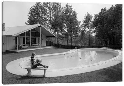 1950s 1960s Blond Woman Bathing Suit Sitting On Stone Bench Beach Ball Near Kidney Shaped Swimming Pool Canvas Art Print - Swimming Pool Art