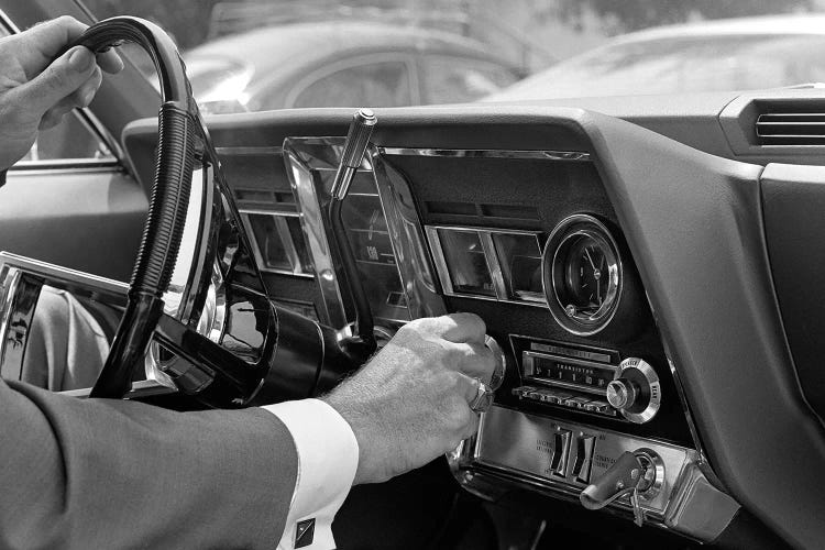 1960s Hand On Car Radio Dials And Steering Wheel