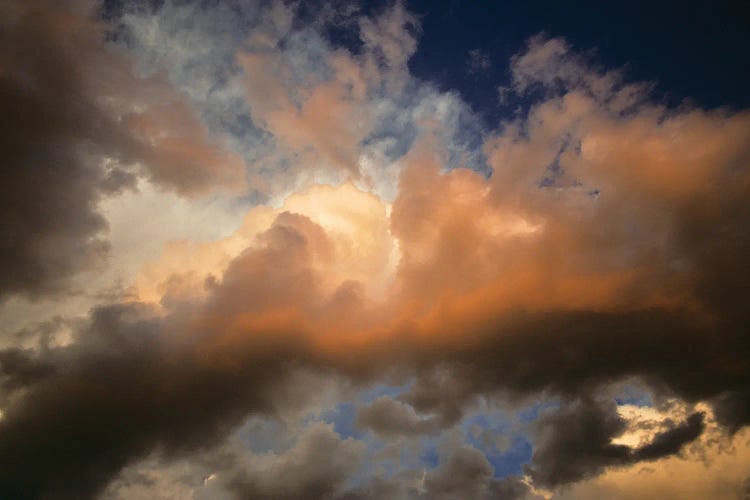 Sunlight Coming Through Rolling Dark Storm Clouds