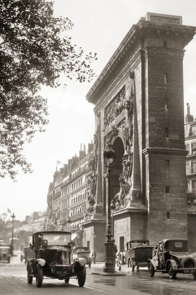 Arches: 1920s Automobiles Passing Porte Saint Denis Arch At Saint Denis Boulevard First Of Four Triumphal Monuments In Paris France by Vintage Images