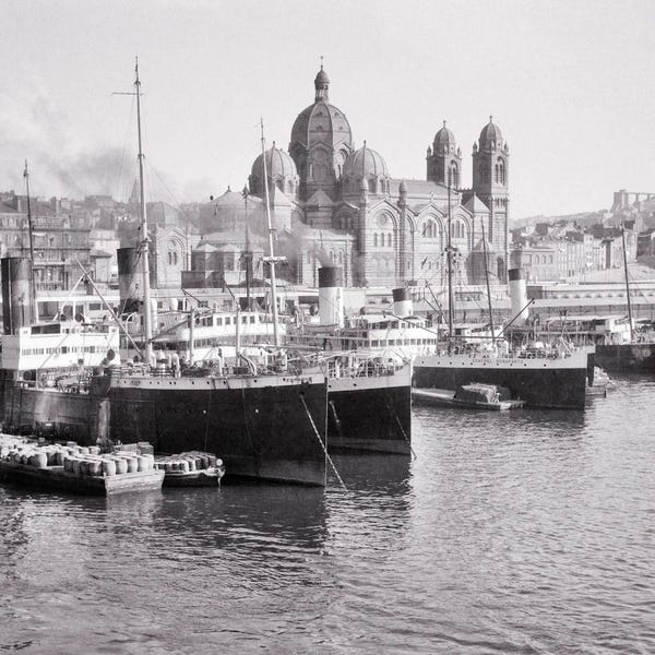 Marseille: 1920s Cargo Ships Docked In Old Port The Cathedral And Basilica Notre-Dame De La Garde Beyond On Hilltop Marseille France by Vintage Images