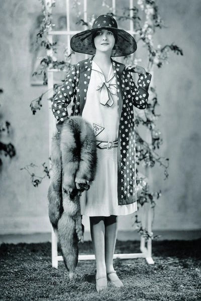 1920s Woman Looking At Camera Wearing Polka Dot Coat Over Dress With Very Fashionable Red Fox Fur Stole And Big Hat