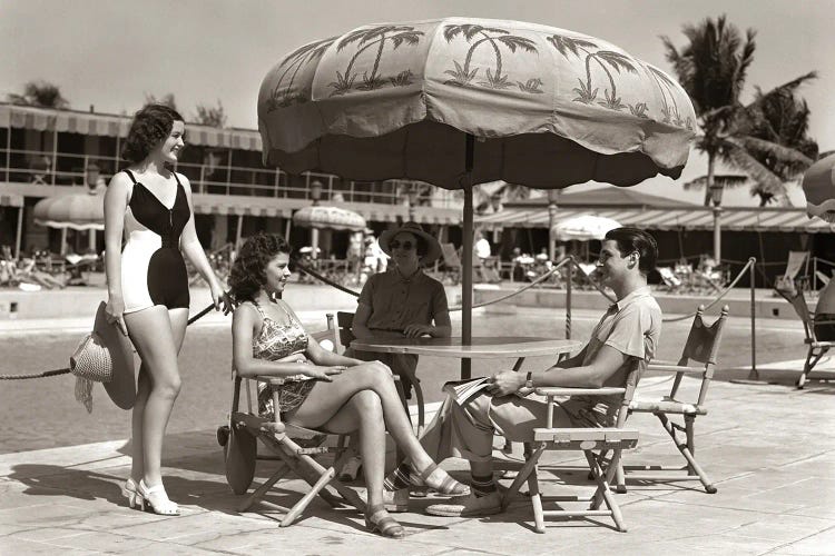 1930s 1940s 3 Women Bathing Suits Single Man Casual Clothes Sitting Talking Under Pool Side Umbrella Miami Beach Florida USA