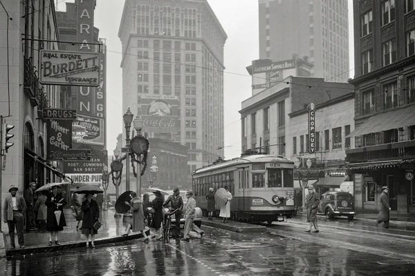Georgia: 1930s 1940s Peachtree Street Shops Signs Cars Public Trolley And Pedestrians Shoppers Walking In The Rain Atlanta Georgia USA by Vintage Images