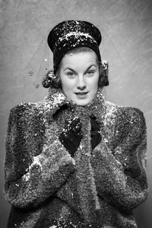 1930s 1940s Woman Wearing Persian Lamb Coat Hat Bundling Up Against Falling Snow Flakes Looking At Camera