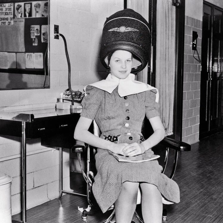 1930s Smiling Woman Looking At Camera Sitting Under Electric Hair Dryer In Professional Beautician Training School by Vintage Images wall art