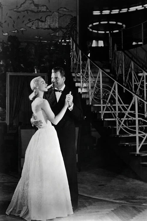 1940s Romantic Couple Man And Woman Formally Dressed Dancing Near Art Deco Staircase