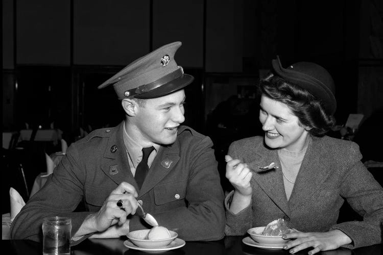 1940s Smiling Couple Man Soldier In Army Uniform And Woman Girlfriend Sitting At Soda Fountain Counter Eating Dish Of Ice Cream