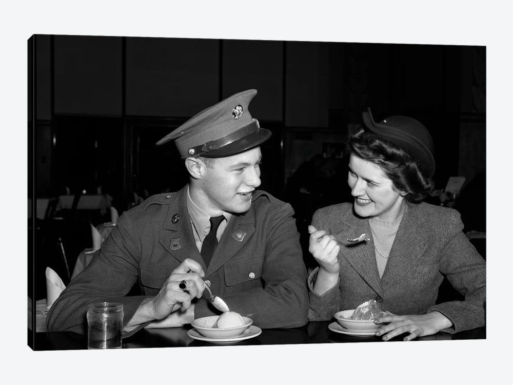 1940s Smiling Couple Man Soldier In Army Uniform And Woman Girlfriend Sitting At Soda Fountain Counter Eating Dish Of Ice Cream by Vintage Images 1-piece Canvas Print