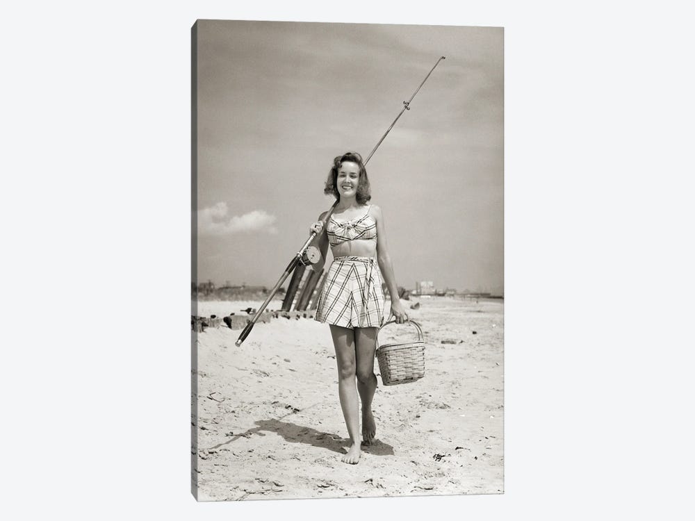 1940s Smiling Young Woman Walking On Beach Looking At Camera Wearing Two Piece Bathing Suit Skirt Carrying Surf Fishing Gear by Vintage Images 1-piece Canvas Art Print