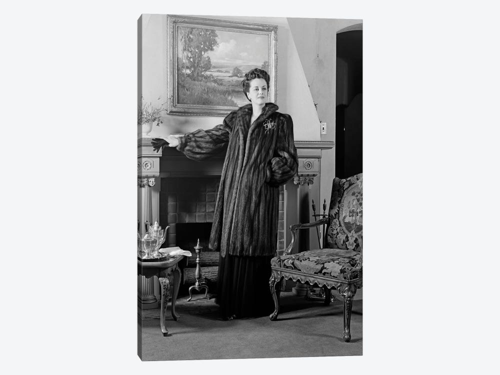 1940s Woman In Formal Living Room Standing In Front Of Fireplace Wearing Full-Length Fur Looking At Camera by Vintage Images 1-piece Canvas Art