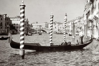 1950s Anonymous Businessman Riding In Gondola Rowing Boat On The Grand Canal The Rialto Bridge In Background Venice Italy by Vintage Images canvas print