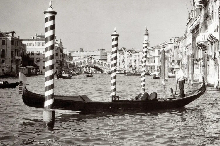 1950s Anonymous Businessman Riding In Gondola Rowing Boat On The Grand Canal The Rialto Bridge In Background Venice Italy