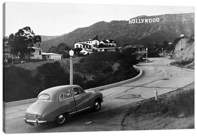 1950s Austin Car Driving Up The Hollywood Hills With Hollywood Sign In Distance Los Angeles Ca USA Canvas Art Print - Signs