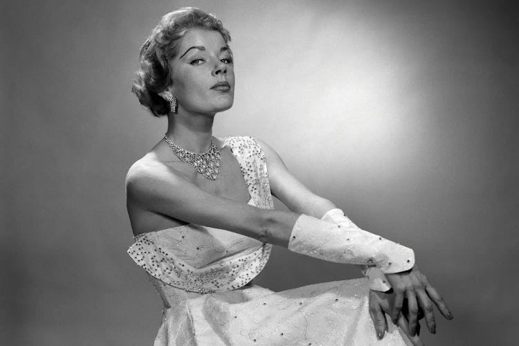 1950s Portrait Of Woman Dressed In Evening Gown With Beaded Cuffs And Jewelry With A Haughty Facial Expression Looking At Camera