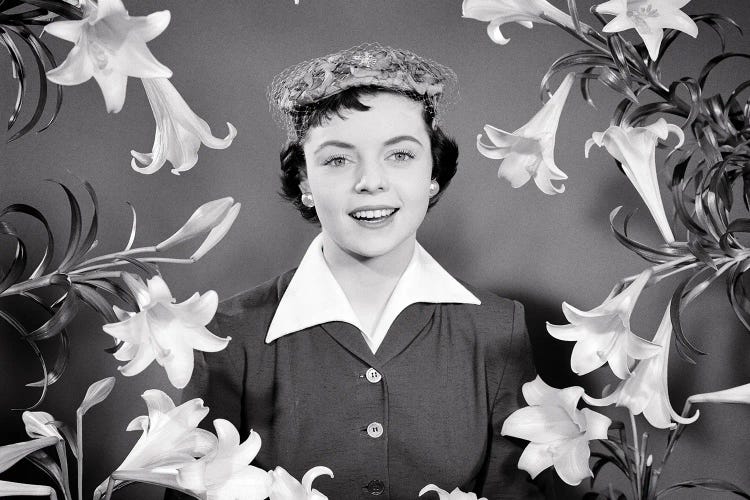 1950s Portrait Smiling Brunette Woman Wearing Easter Bonnet Hat Looking At Camera Surrounded Framed By Easter Lilies