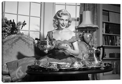 1950s Smiling Blond Woman Elegant Dress & Home Furnishings Pouring Cup Tea From Silver Service Sitting Couch Looking At Camera Canvas Art Print - Vintage Images