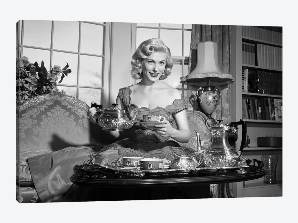 1950s Smiling Blond Woman Elegant Dress & Home Furnishings Pouring Cup Tea From Silver Service Sitting Couch Looking At Camera by Vintage Images 1-piece Canvas Art Print