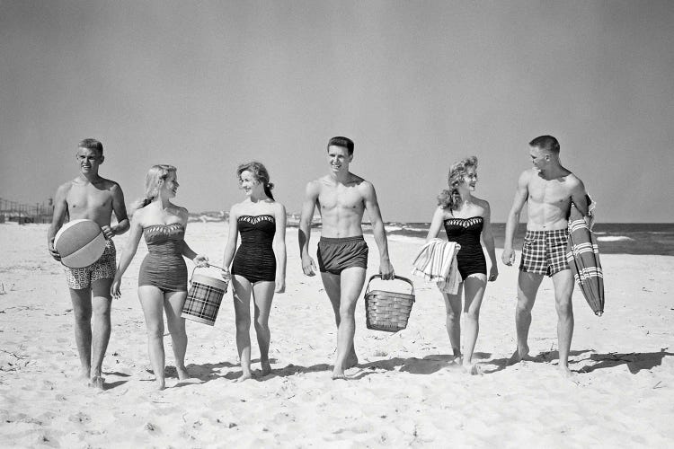 1950s Three Teenage Couples Walking On Beach Carrying Picnic Basket And Cooler