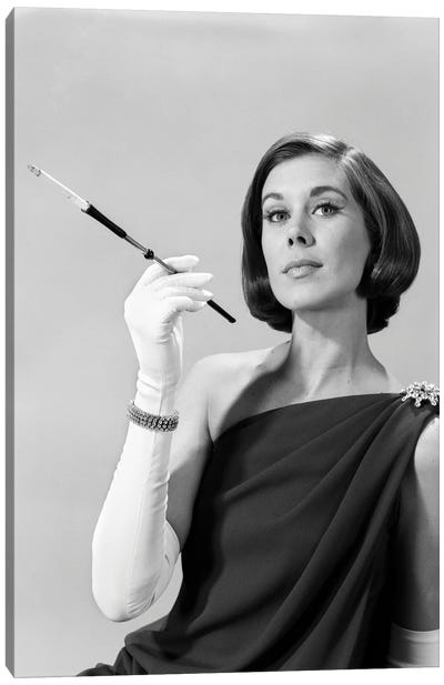 1960s Formally Elegantly Dressed Young Woman Arrogant Expression Holding Long Cigarette Holder Wearing Long White Gloves Canvas Art Print - Vintage Images