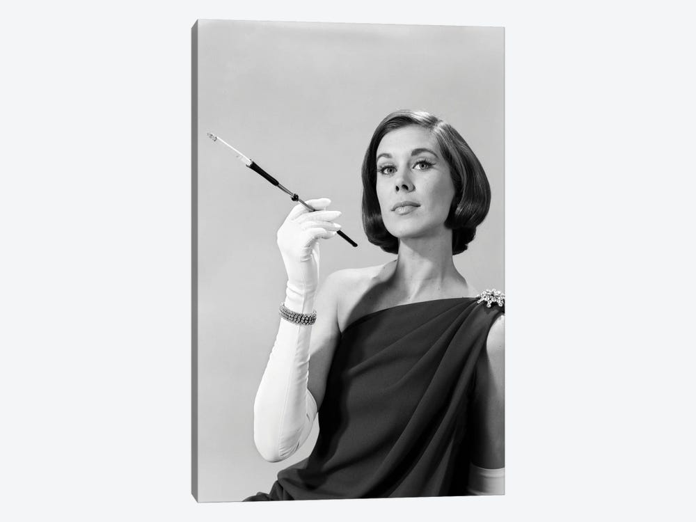 1960s Formally Elegantly Dressed Young Woman Arrogant Expression Holding Long Cigarette Holder Wearing Long White Gloves by Vintage Images 1-piece Art Print