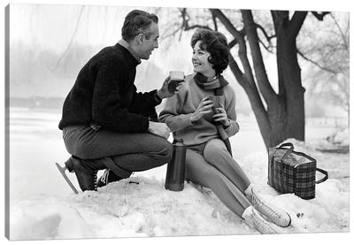 1960s Smiling Couple In Snow Wearing Ice Skates Drinking Hot Beverage From Thermos Canvas Art Print - Vintage Images