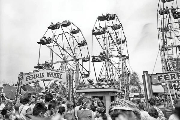 Ferris Wheels: 1960s Teens Lined Up At Ticket Both To Ride On One Of Three Ferris Wheels At County Fair by Vintage Images