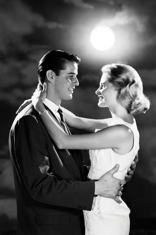 1960s Young Couple Embracing In Moonlight