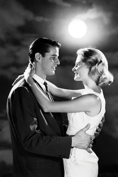 Historical Fashion: 1960s Young Couple Embracing In Moonlight by Vintage Images