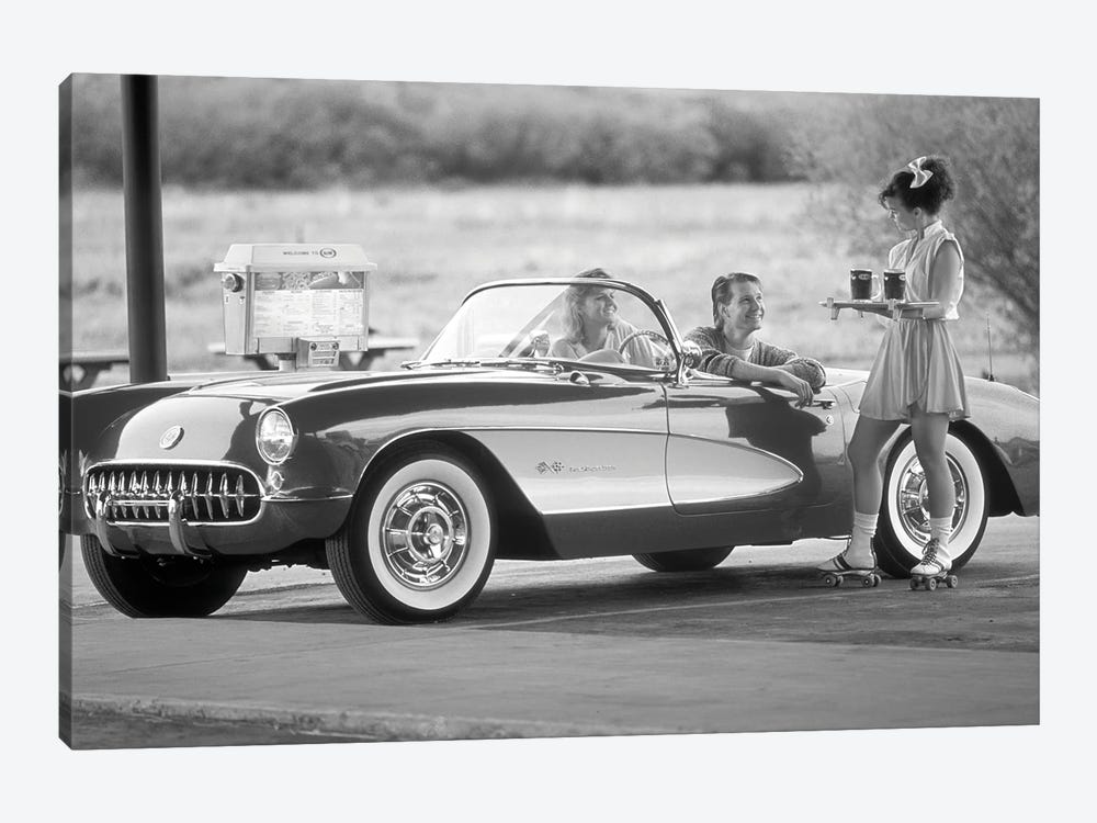 1980s 1990s Carhop On Roller Skates Serving Drinks To Couple In Old Corvette Convertible At 1950s Style Drive-In Restaurant by Vintage Images 1-piece Canvas Print