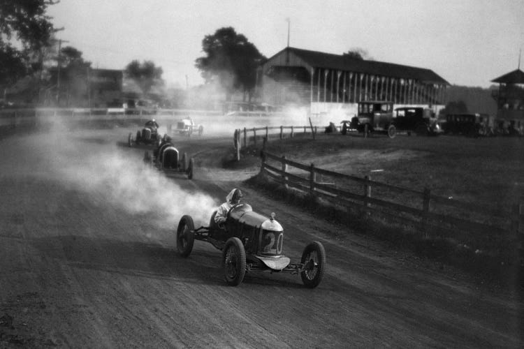 1930s Auto Race On Dirt Track With Cars Going Around Turn Kicking Up Dust