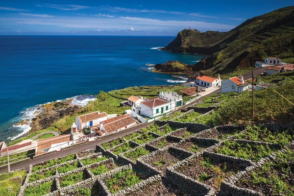 Portugal, Azores, Santa Maria Island, Maia. Elevated view of town and volcanic rock vineyards