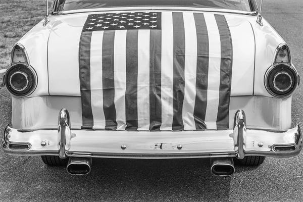 American Flags: USA, Massachusetts, Essex. Antique cars, detail of 1950's-era Ford draped with US flag. by Walter Bibikow