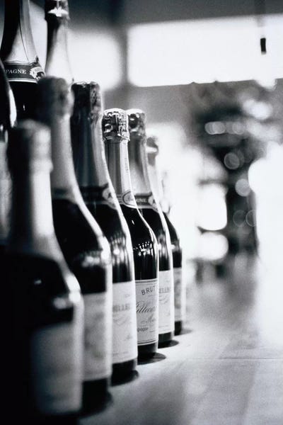 Walter Bibikow: A Row Of Champagne Bottles by Walter Bibikow