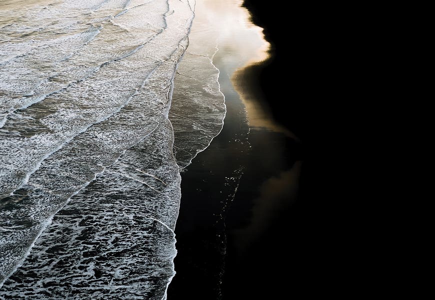 Minimal Waves Crashing On A Black Sand Beach In Iceland During Sunset by Michael Schauer