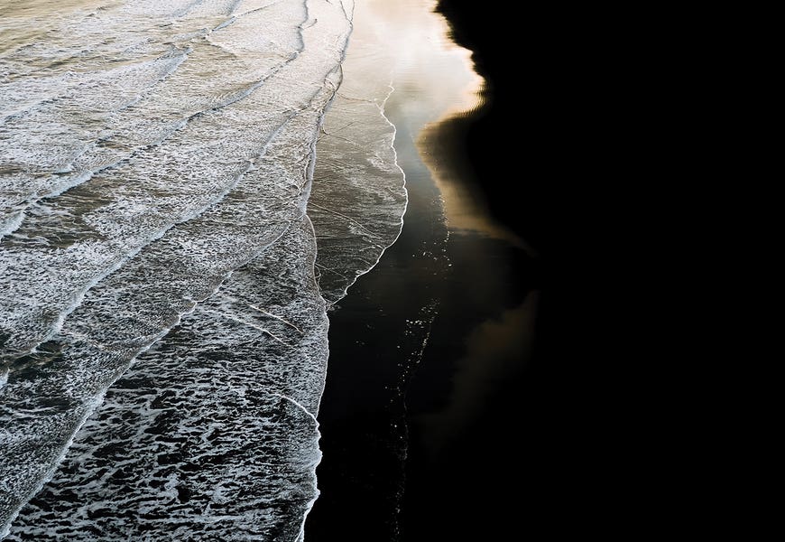 Minimal Waves Crashing On A Black Sand Beach In Iceland During Sunset by Michael Schauer