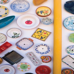 Colorful Plates At Wall by Gilliard Bressan