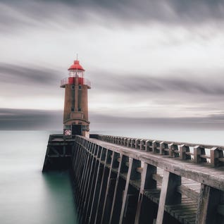 A Lighthouse At The Port by Karim Carella