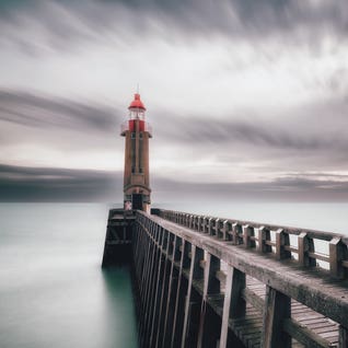 A Lighthouse At The Port by Karim Carella